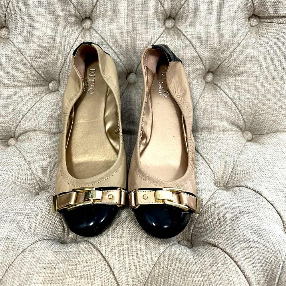 Tan and black ballet flat with gold buckle detail